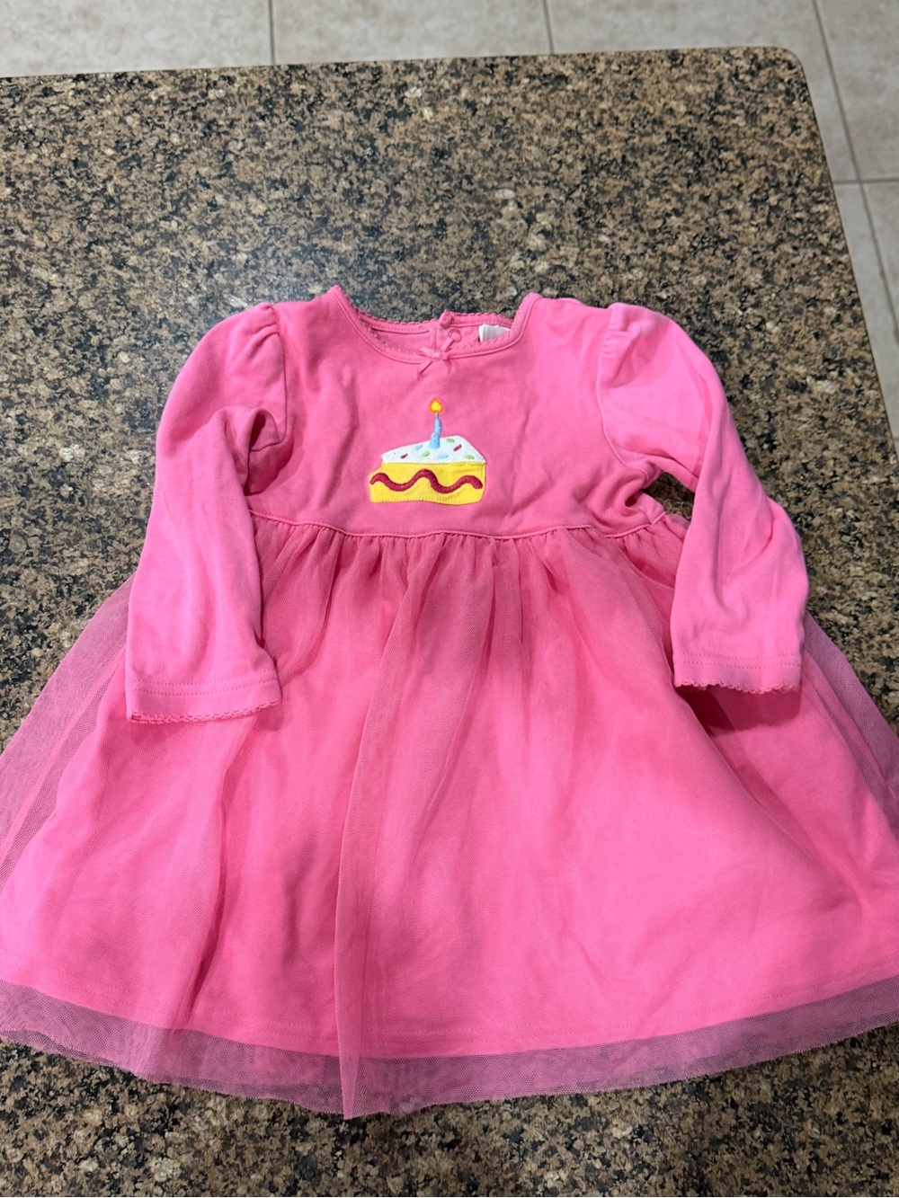 Carter's toddler dress features an adorable embroidered birthday cake